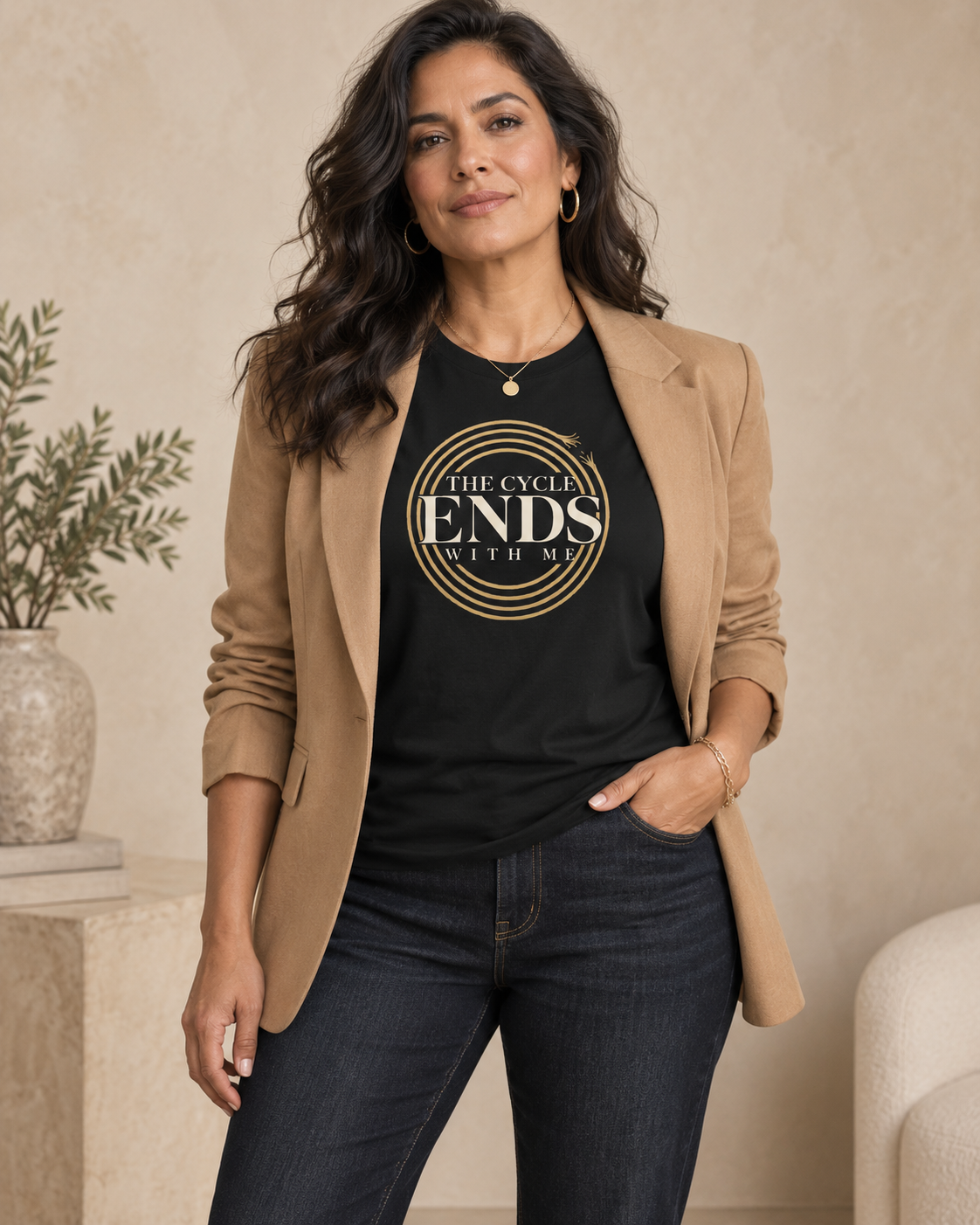 Woman wearing The Cycle Ends With Me black relaxed T-shirt with a tan blazer.