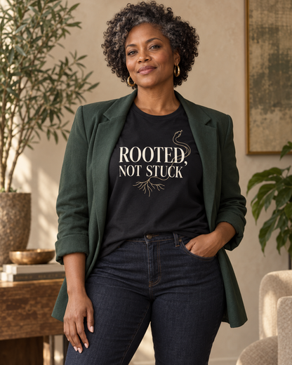 Woman wearing the Rooted, Not Stuck black relaxed T-shirt with a forest-green blazer.